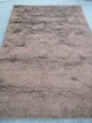 A hand knotted shaggy chocolate brown rug,