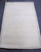 A hand knotted beige rug,
