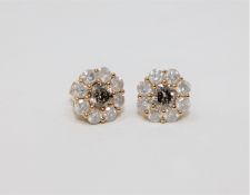 A pair of 18ct yellow gold diamond stud earrings featuring two round brilliant cut cognac diamonds