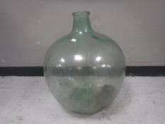An antique green glass carboy