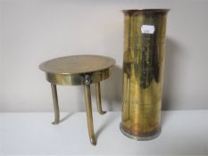 A brass trench art trivet together with a brass ammunition shell