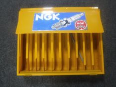 An NGK metal counter top spark plug display stand
