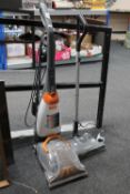 An upright Vax rapide carpet cleaner together with a G-tech cordless carpet sweeper