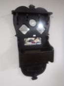 An antique hall mirror fitted with a glove box