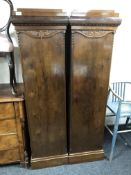 A pair of early twentieth century continental walnut sentry door cabinets fitted shelves internally