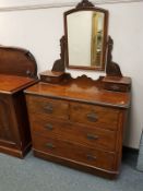 A Victorian walnut dressing chest with mirrored back, width 99 cm.