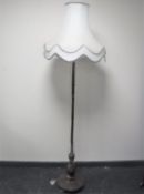 An antique rosewood standard lamp with shade