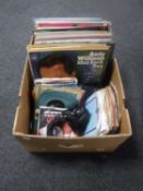 A box containing vinyl LP's and 7