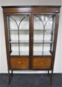 A Victorian inlaid mahogany double door display cabinet