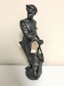 An antique spelter figure of a blacksmith