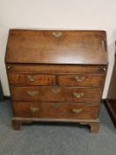 A George III oak bureau, width 93 cm.
