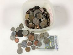 A tub containing pre-decimal British coinage, foreign coins including America, Australia,