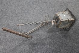 A wrought iron lantern with wall bracket