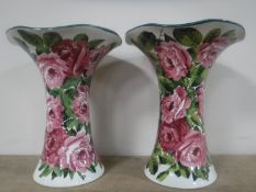 A rare very large pair of Wemyss vases decorated with cabbage rose sprays,