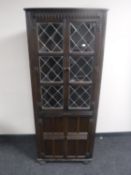An oak leaded door corner cabinet