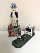 Two cast iron novelty money boxes;