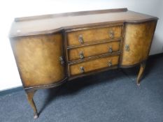 A walnut Queen Anne style shaped sideboard