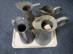 A tray of five copper and brass jugs