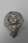 A vintage badge marked 'Praetio Prudentia Prestat'