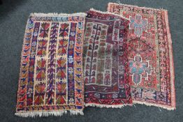 Three fringed Persian rugs