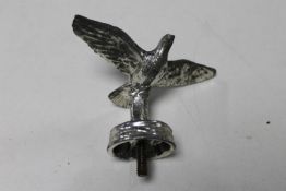 A bird in flight car mascot