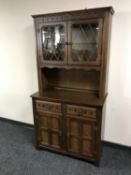 An oak leaded glass door dresser
