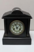 A Victorian black slate mantel clock with brass and enamelled dial