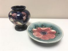 A Moorcroft squat vase, with flowers on a dark blue ground,