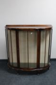 A 1930's walnut D-shaped display cabinet