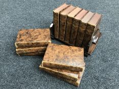 An oak Art Deco book trough together with twelve volumes of British Encyclopaedia