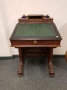 A Victorian mahogany Davenport, width 61 cm, with glass inkwells.