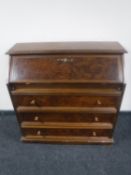 A continental bureau in a walnut finish together with a mahogany double door cabinet fitted a