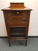A late Victorian inlaid mahogany music cabinet, width 54 cm.