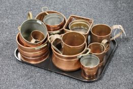A tray containing antique copper pans, tankards,