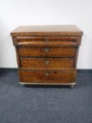 A continental mahogany four drawer chest with pillar supports