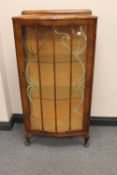 A 1930's walnut single door display cabinet