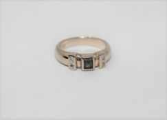 A 14ct white gold emerald and diamond ring,