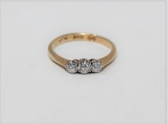 An 18ct gold three stone diamond ring, approximately 0.