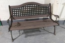 A cast iron and wood garden bench