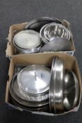 Two boxes containing stainless steel pans, lids, colanders,