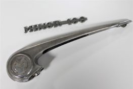 A large bull nose Morris car bonnet ornament and a Morris Minor 100 badge