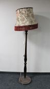 An antique mahogany standard lamp with shade