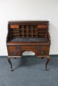 A mahogany Art Nouveau roll top writing desk