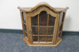 A 20th century oak hanging curio cabinet