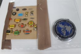 A 50 Years International Motorcycle badge and twenty vintage pin badges relating to motor bikes
