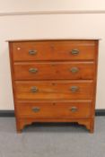 An Edwardian satinwood four drawer chest