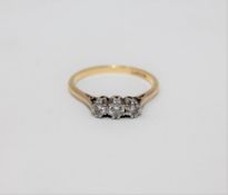 An 18ct and platinum set three stone diamond ring, approximately 0.25ct.