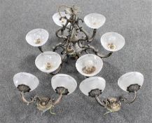 An ornate metal six way light fitting with glass shades together with a pair of double wall lights