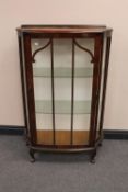 A 1930's walnut single door display cabinet