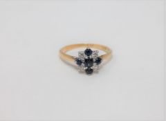 An 18ct gold and platinum set diamond and sapphire ring